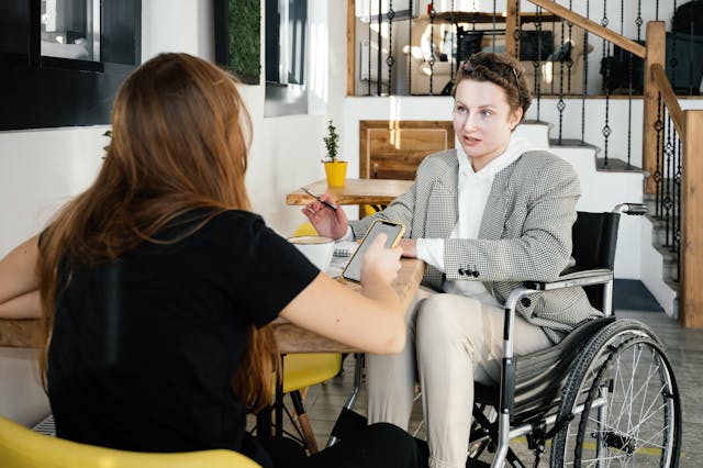 Two people sitting across from eachother at a table